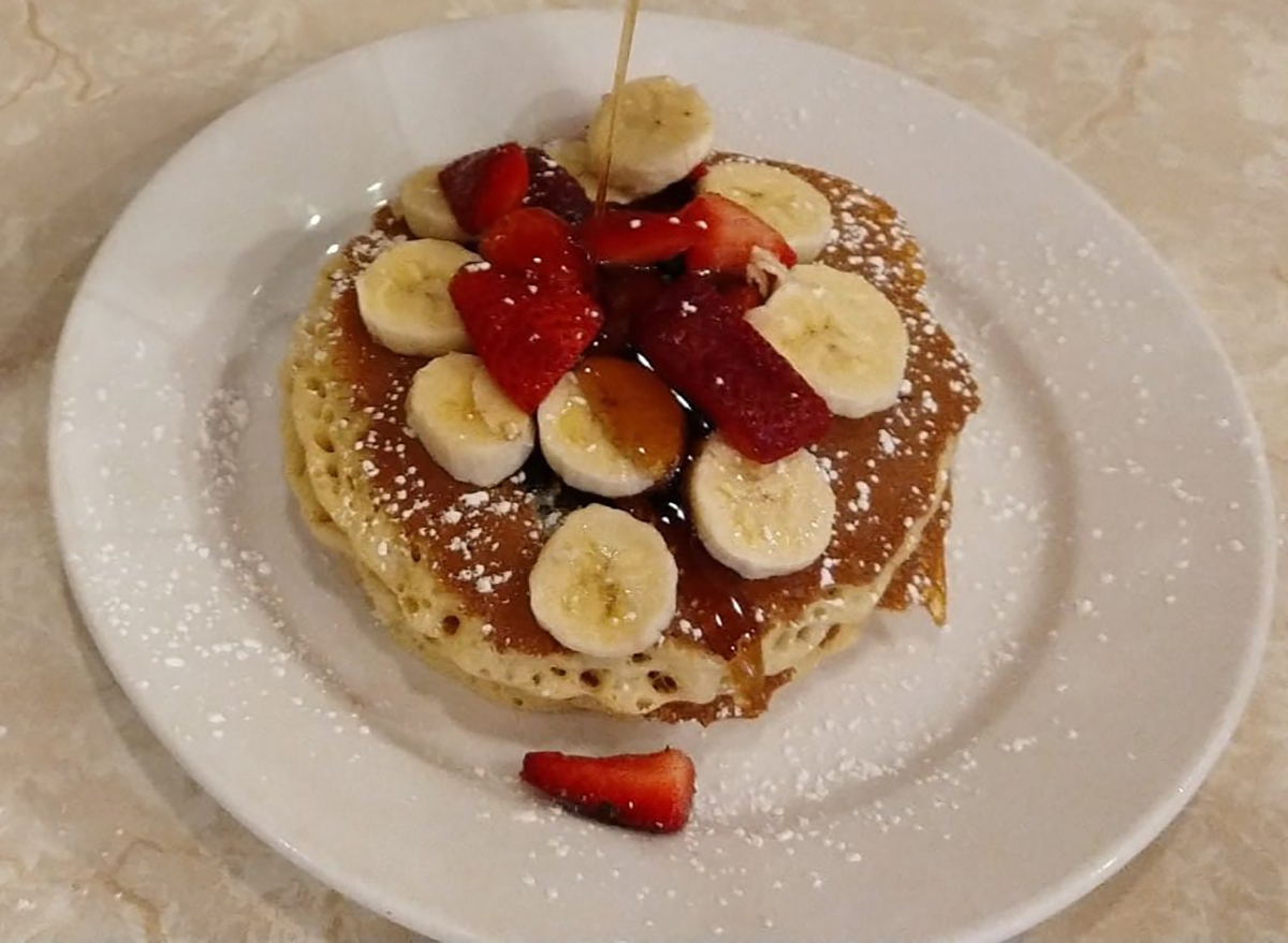 stack of pancakes topped with banana slices