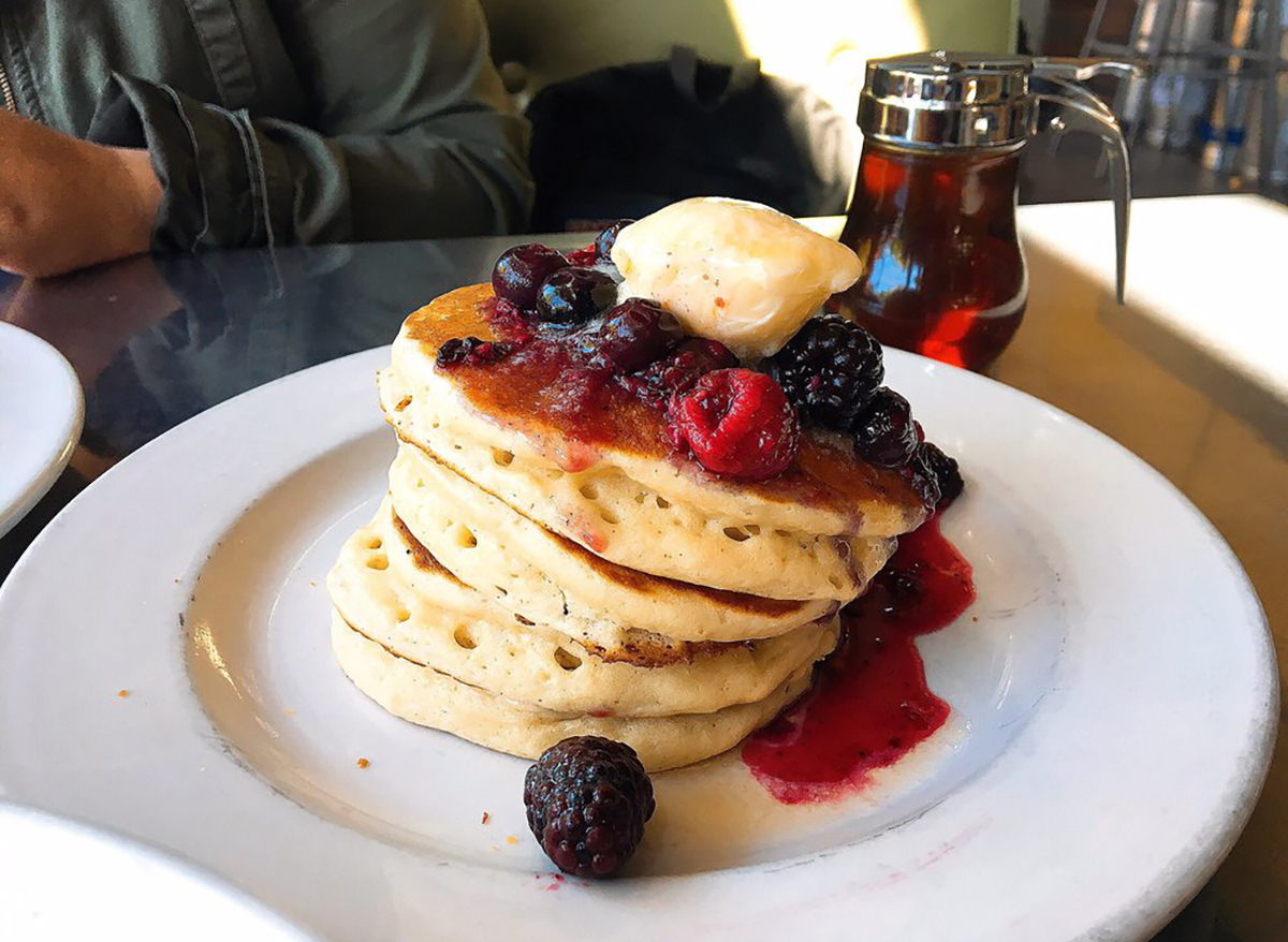 stack of pancakes with berries and lemon butter