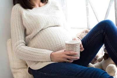 pregnant woman drinking coffee