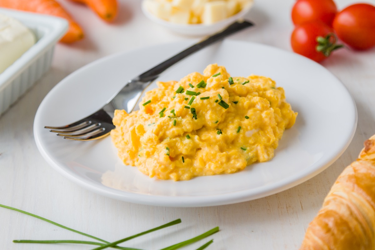 scrambled eggs with chives on white plate