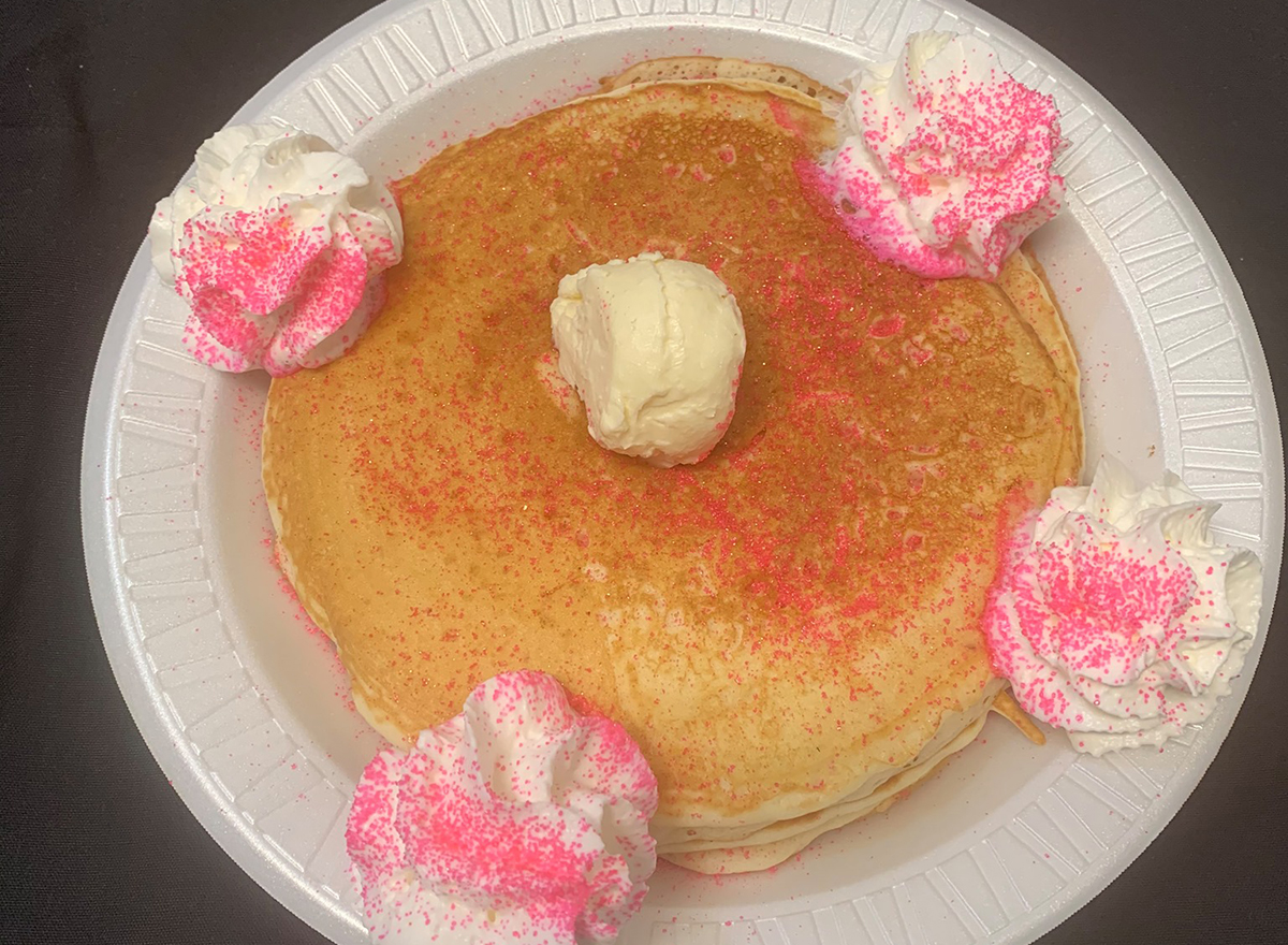 sugar cookie pancakes with whipped cream and pink sprinkles