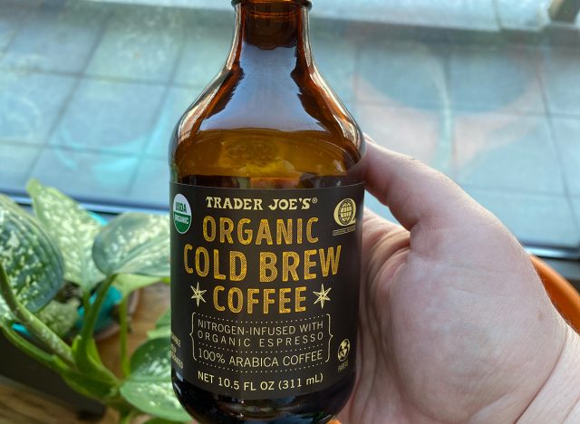 hand holding bottle of organic trader joes cold brew