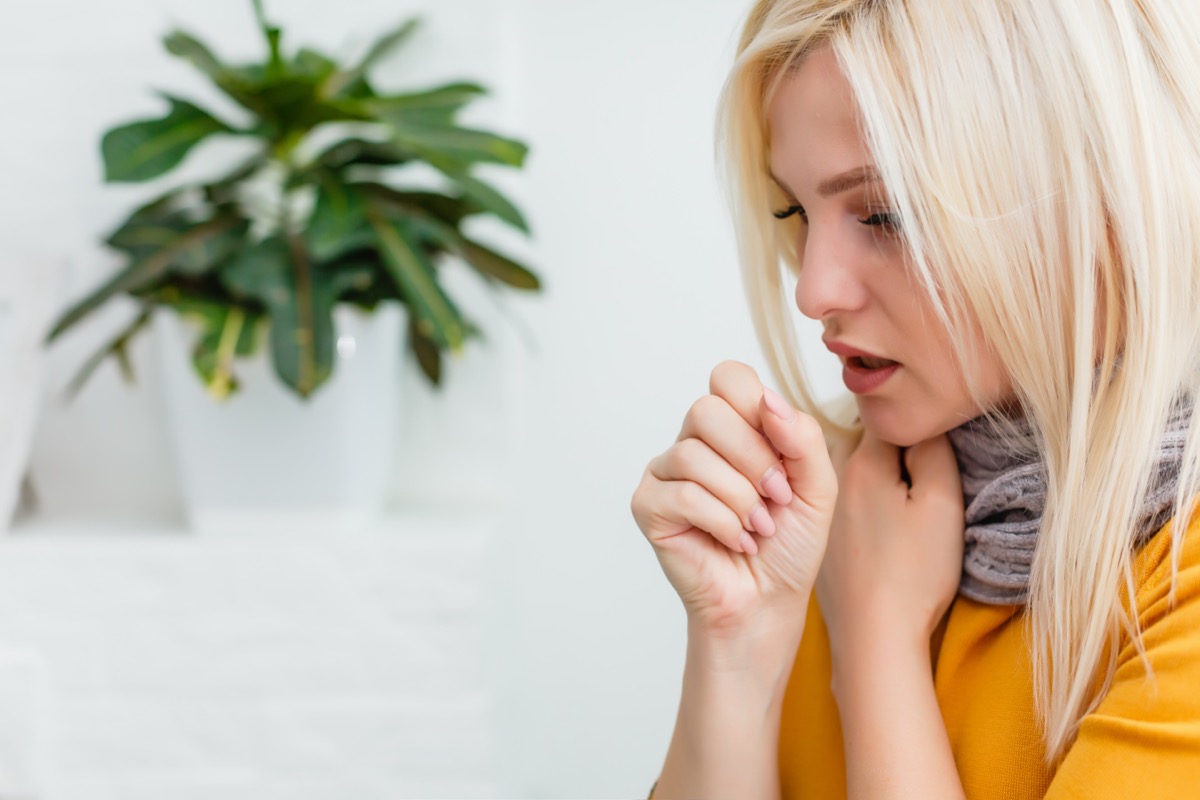 Blonde woman coughing.