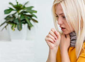 Blonde woman coughing.