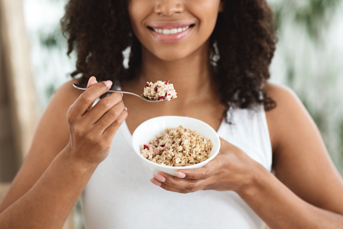 young woman eating oatmeal