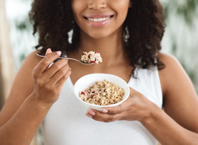 young woman eating oatmeal