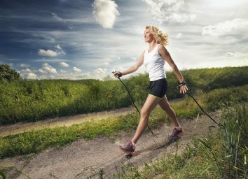 woman nordic walking outdoors with proper form