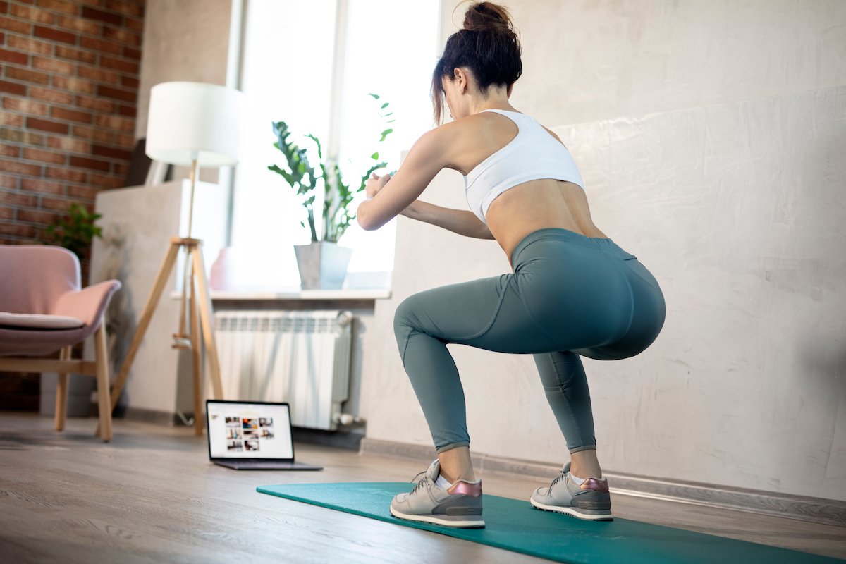 Young sporty slim woman coach internet video online fitness training instructor modern laptop screen. Healthy lifestyle concept, online fitness and sport lessons.