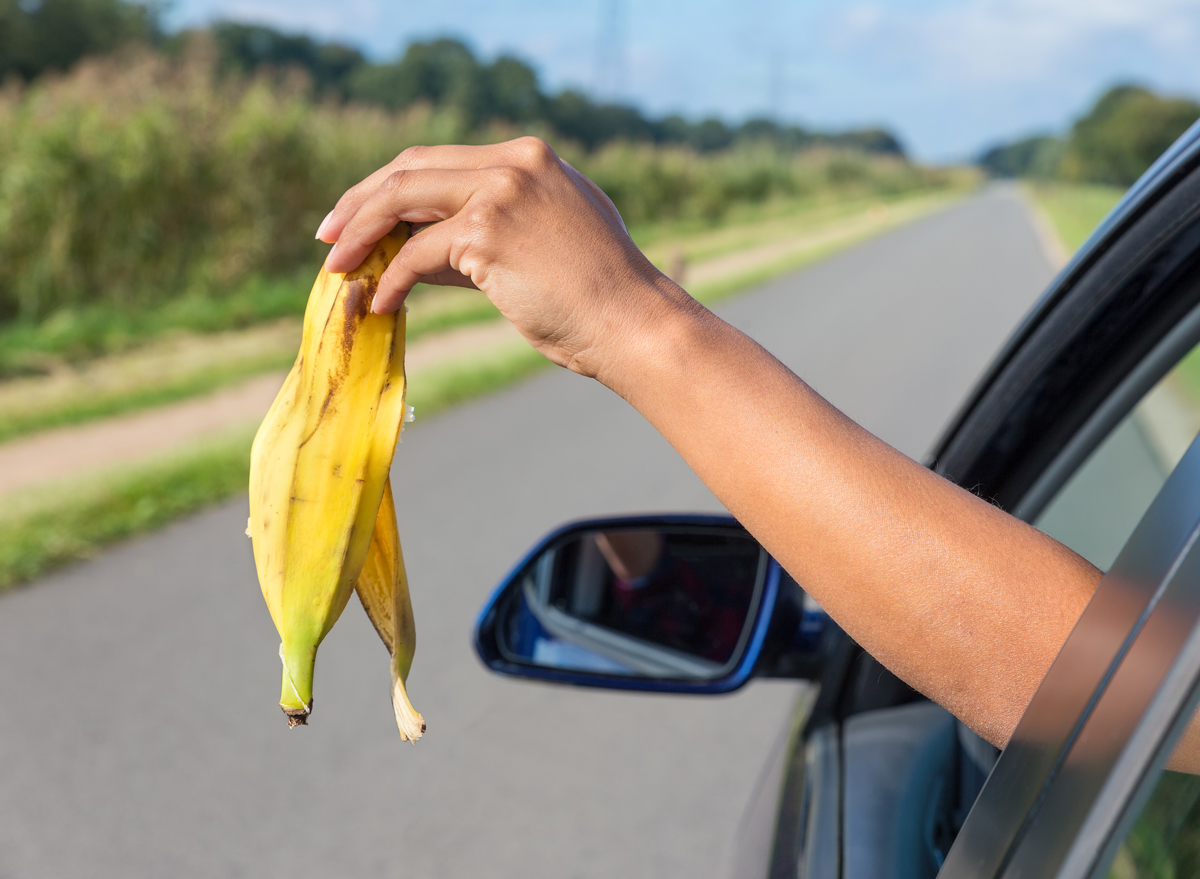 woman throwing banana out of car