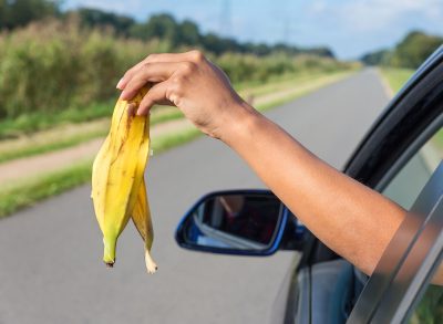 woman throwing banana out of car