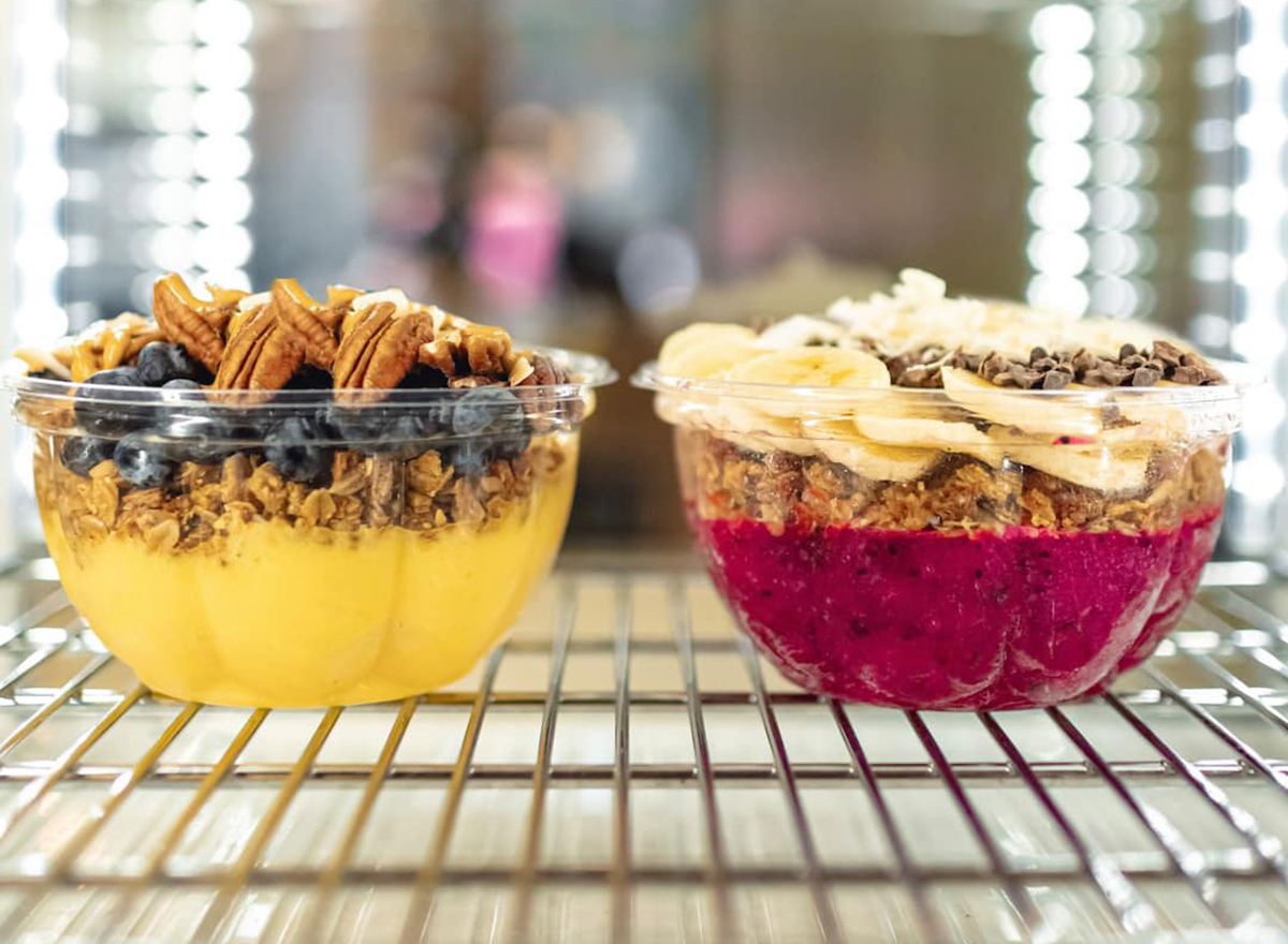 two smoothie bowls on a to-go rack