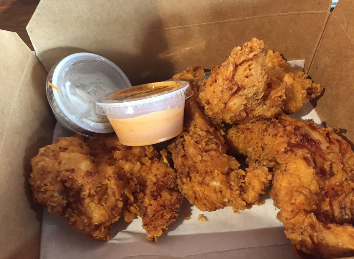 basket of chicken fingers with sauce