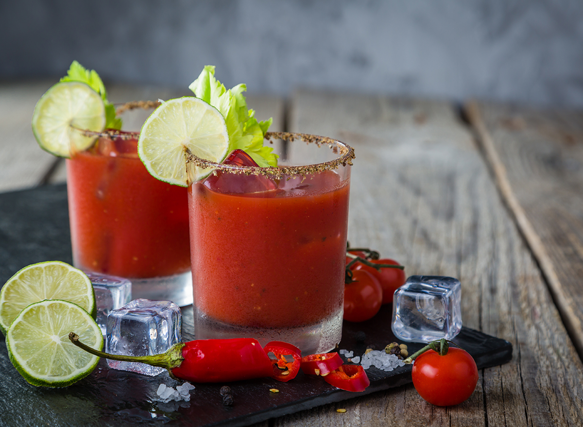 two bloody mary cocktails with lime garnish