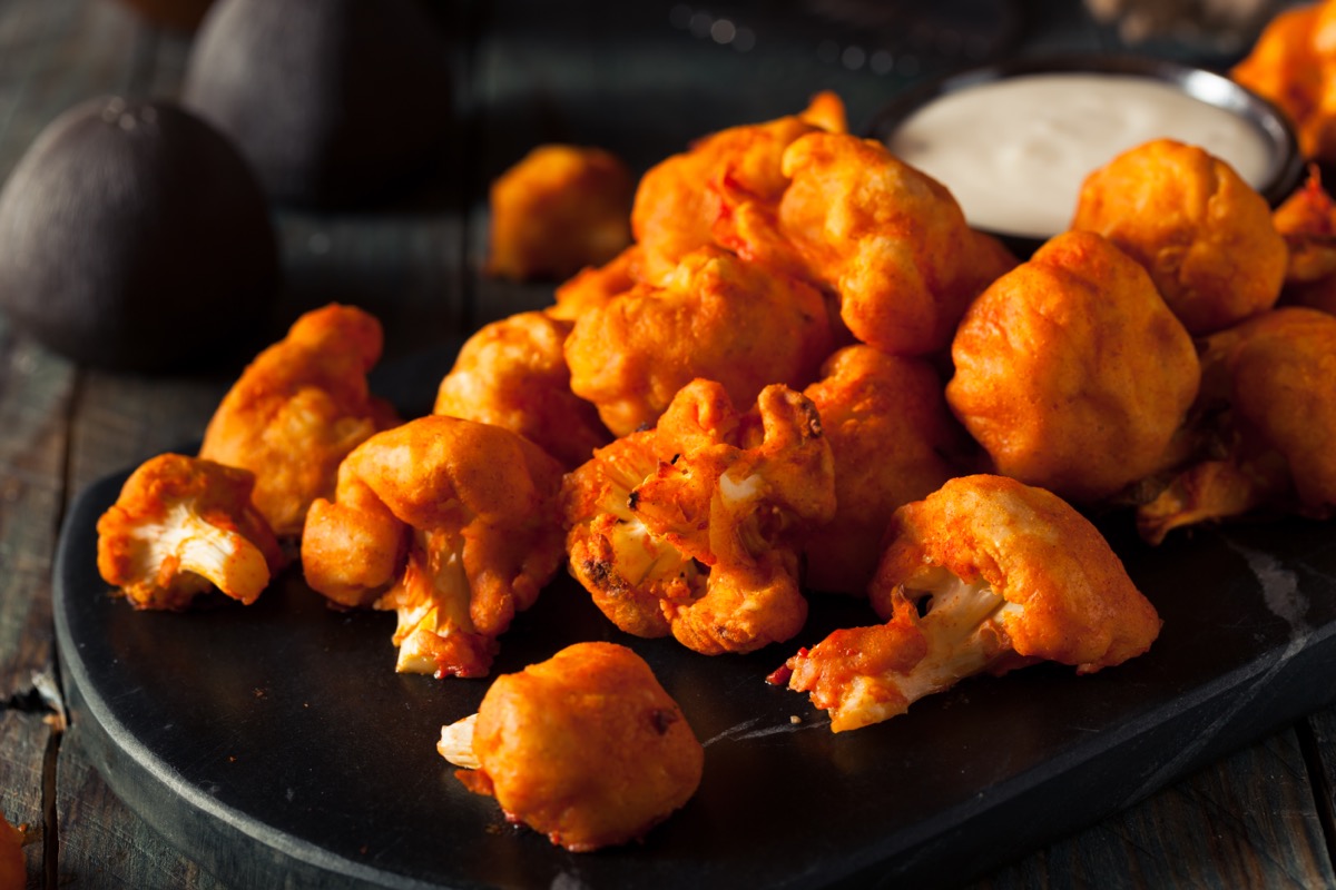 buffalo cauliflower and blue cheese dressing on black plate