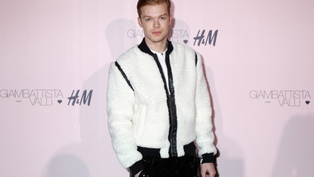 cameron monaghan in white jacket with black trim on red carpet