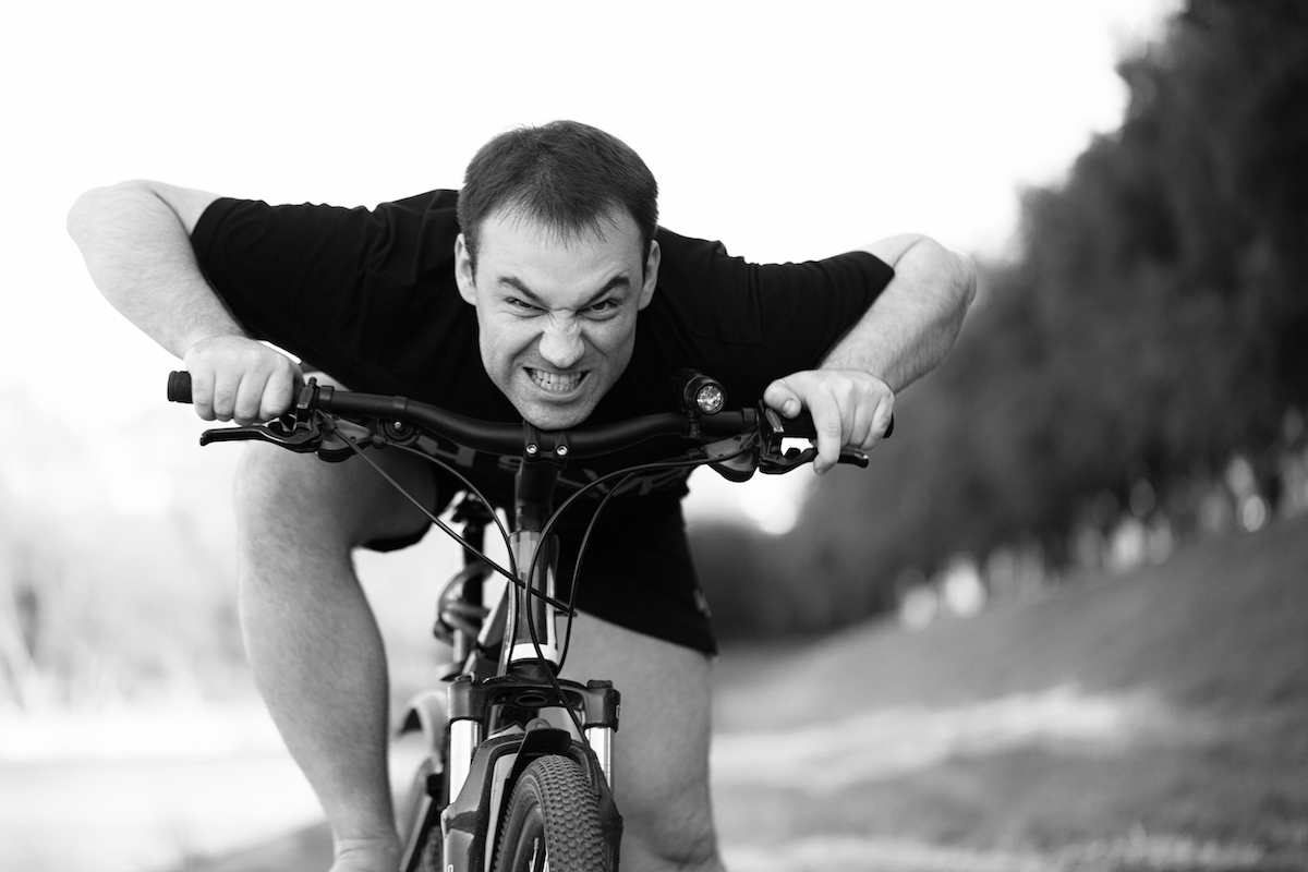 the Angry Grimacing Bicyclist Rides Bicycle Closeup
