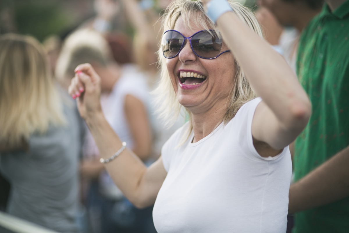 Mature woman enjoying music concert.