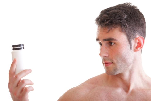 Man holding a box with supplements.