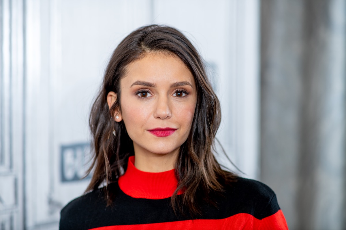 nina dobev in black and red shirt