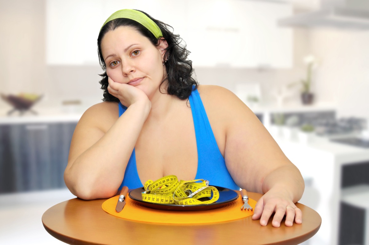Large girl eating a measuring tape