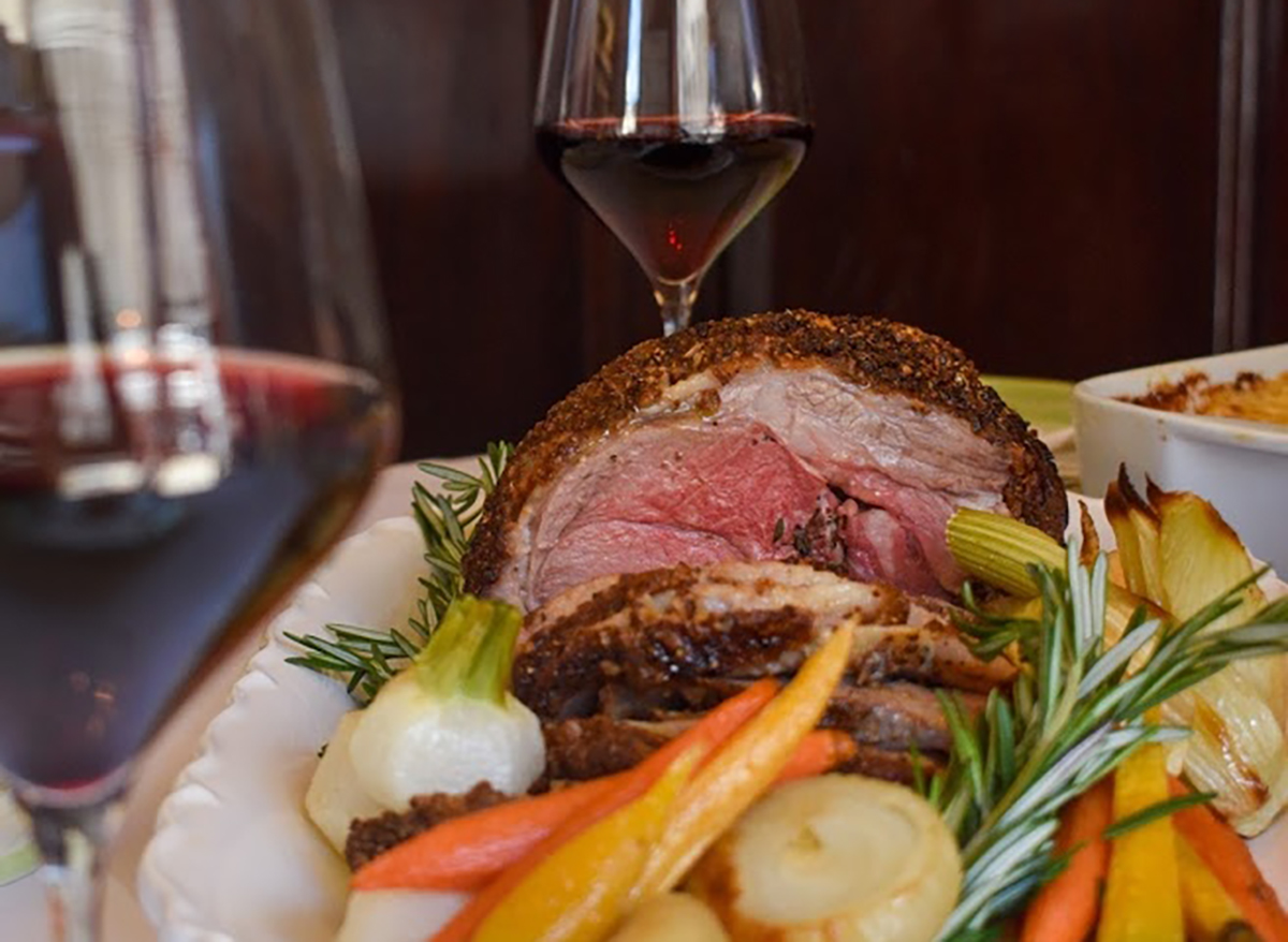 filet mignon roast with vegetables and wine glasses