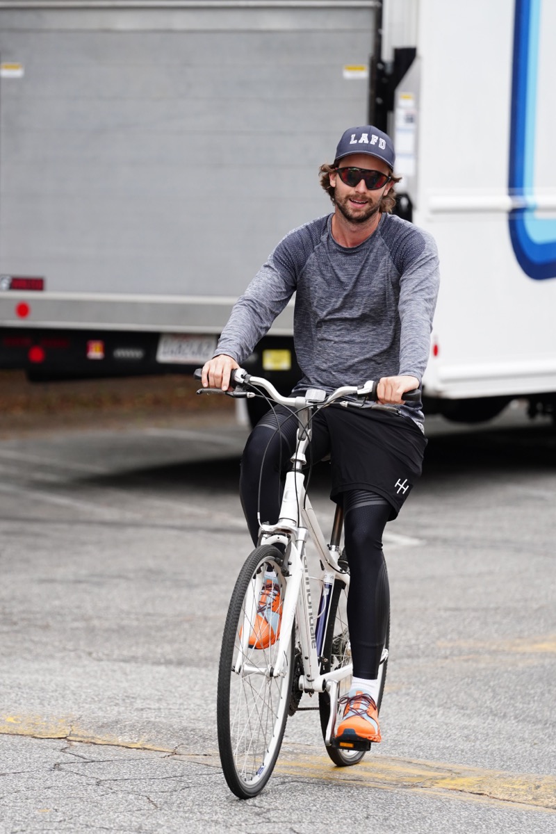 patrick schwarzenegger biking in gray shirt