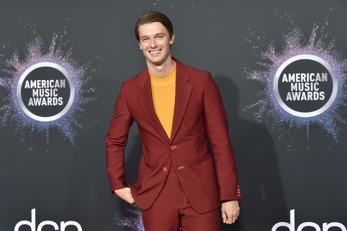 patrick schwarzenegger in red suit and yellow shirt on red carpet