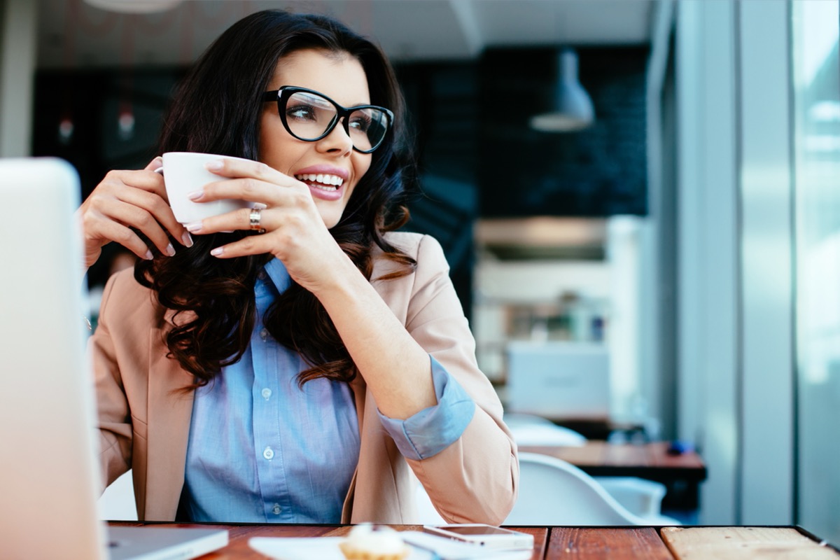 woman wearing glasses and drinking coffee