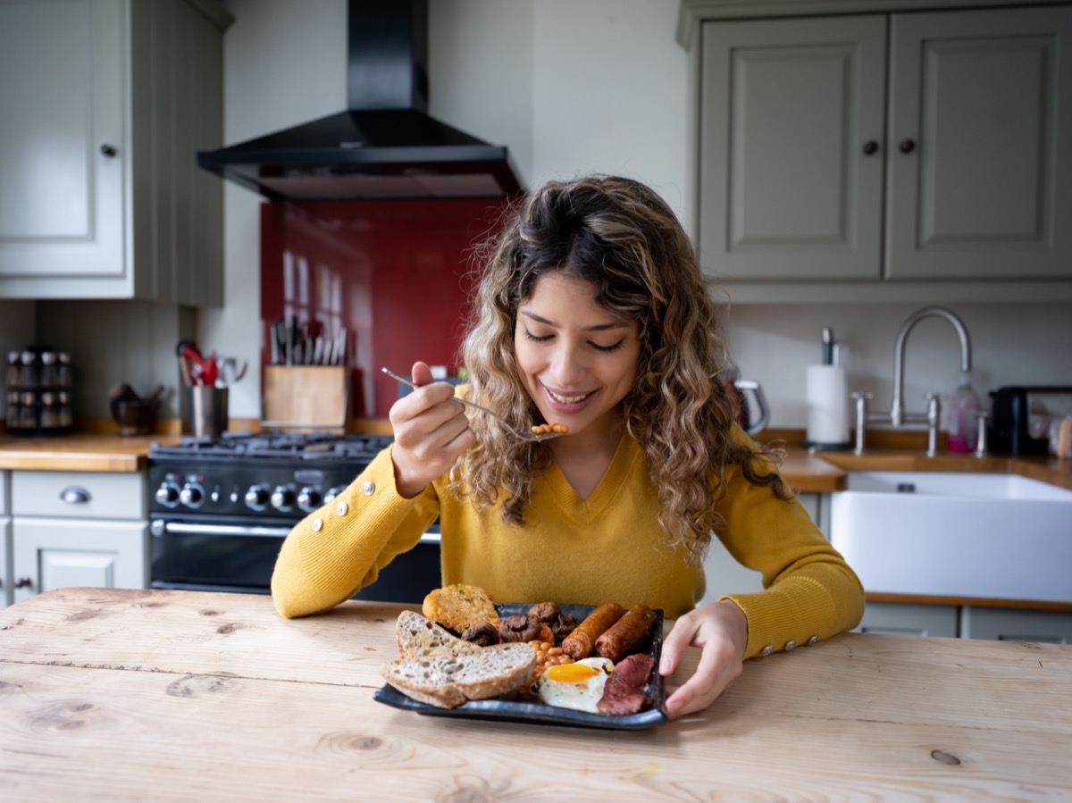 Woman at home eating english breakfast