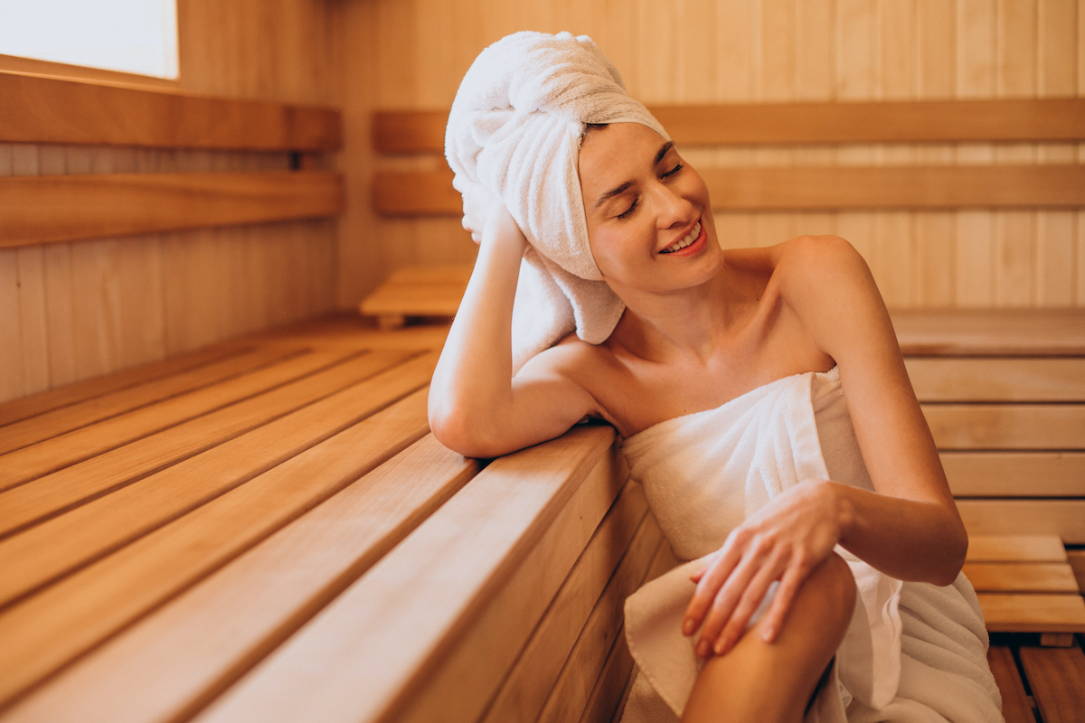 Young woman having rest in sauna alone