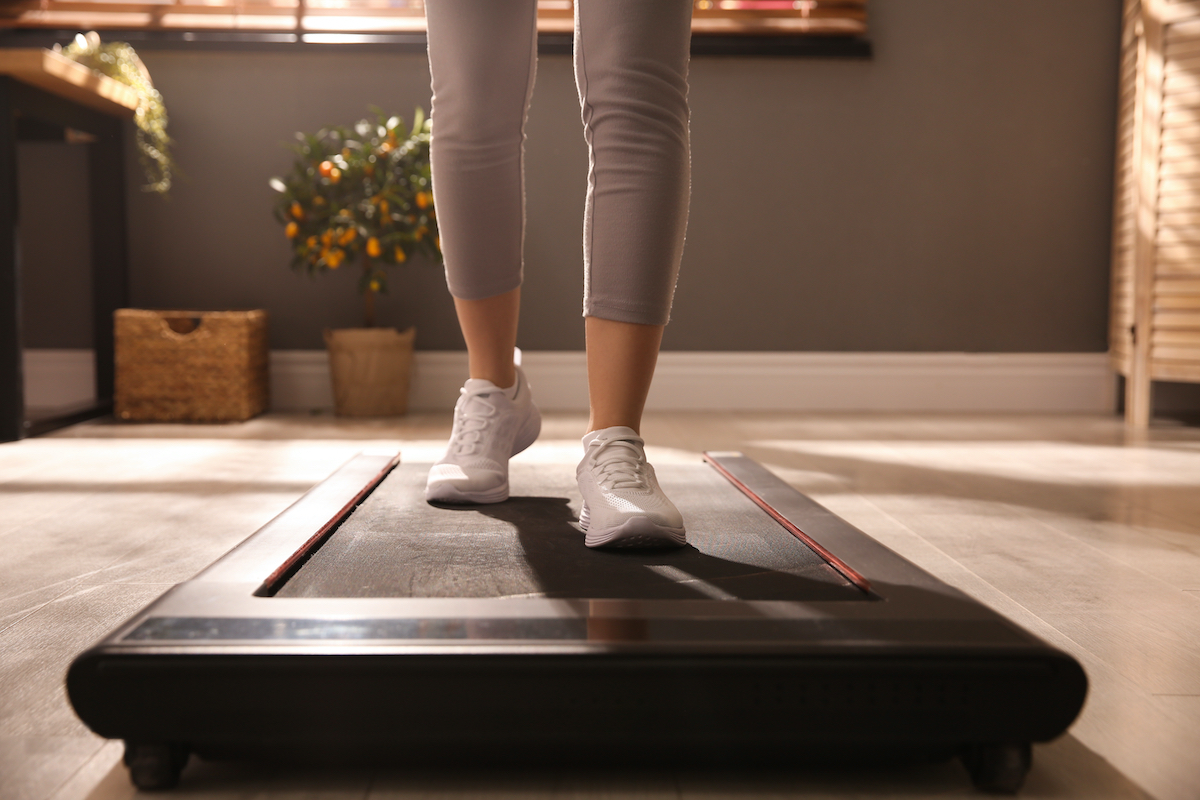 https://www.eatthis.com/wp-content/uploads/sites/4/2021/05/woman-on-treadmill-at-home.jpg?quality=82&strip=1