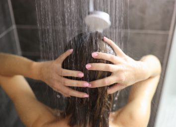 Woman takes shower in the bathroom. Feminine hygiene rules concept