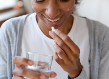 young woman taking supplement