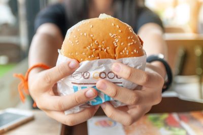 person holding burger king burger