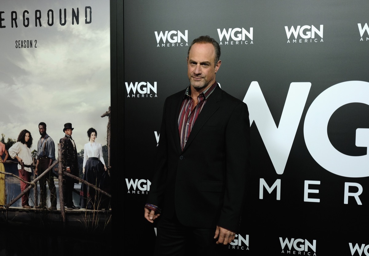 christopher meloni in black suit and red shirt on red carpet