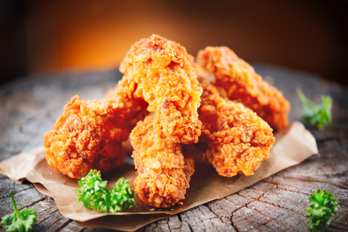 breaded and fried chicken wings with parsley garnish