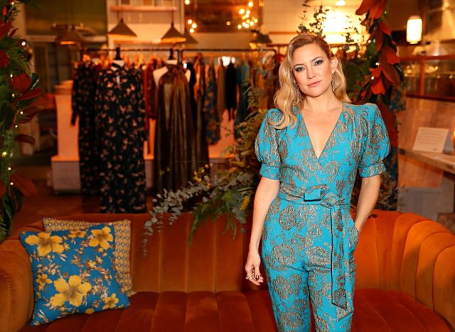 kate hudson in blue jumpsuit in clothing showroom