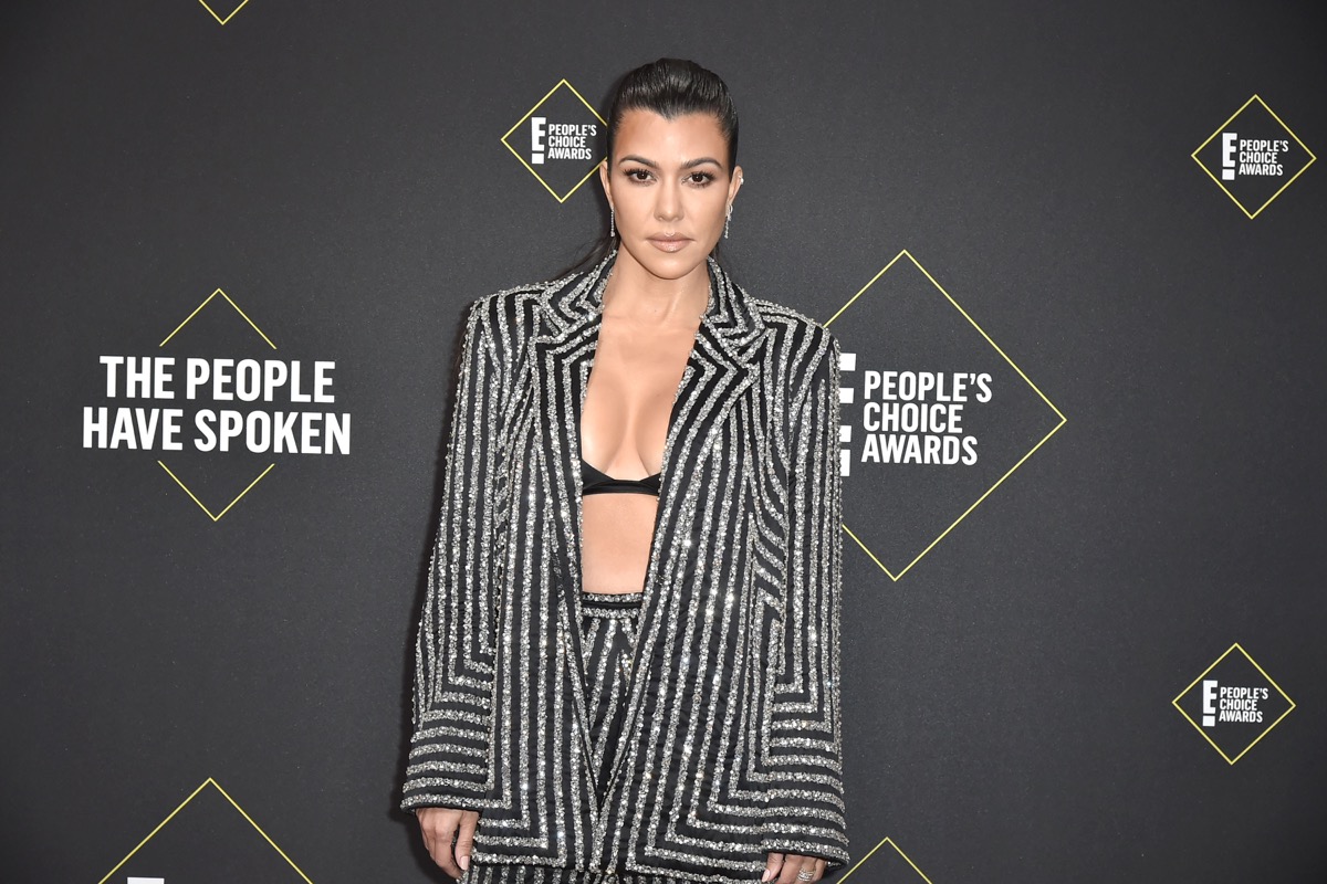 kourtney kardashian in black and silver striped suit