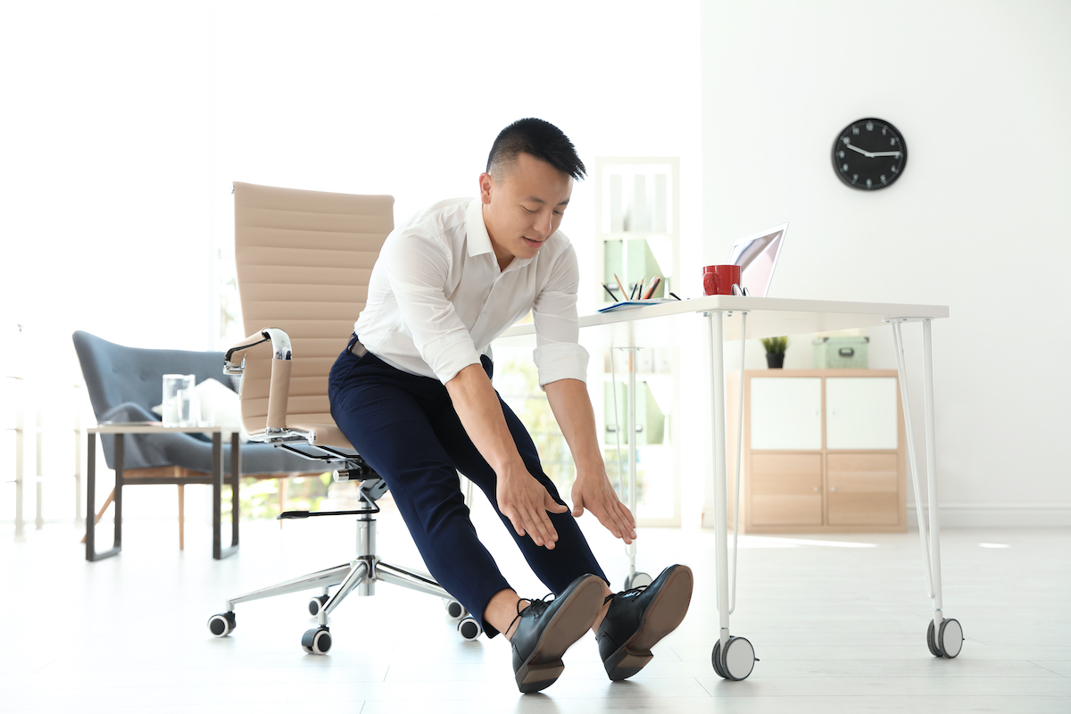 man exercising at his desk