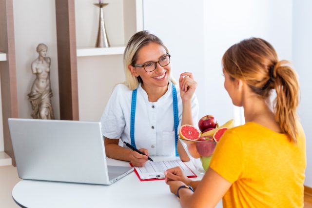 Woman visiting nutritionist in weight loss clinic.
