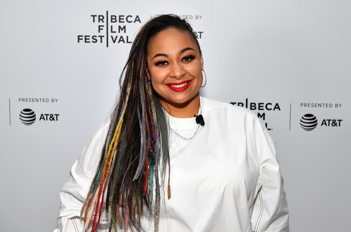 raven symone in white shirt on red carpet