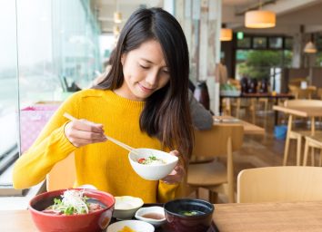 young woman eating japanese food