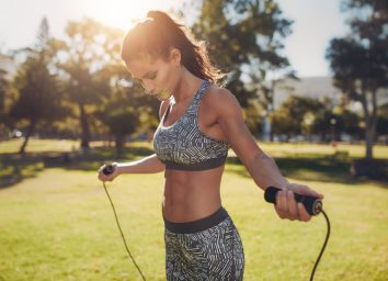 woman doing jump rope exercise outdoors