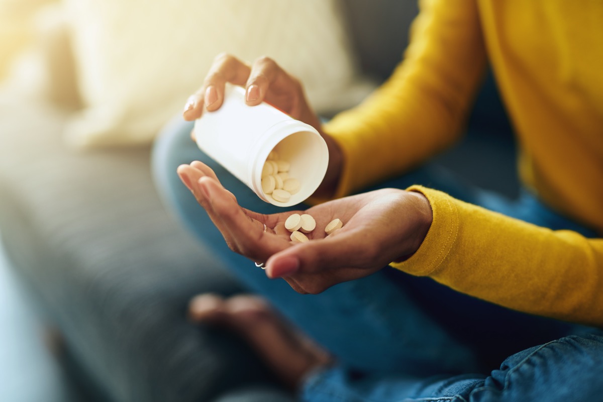 Woman taking medication at home