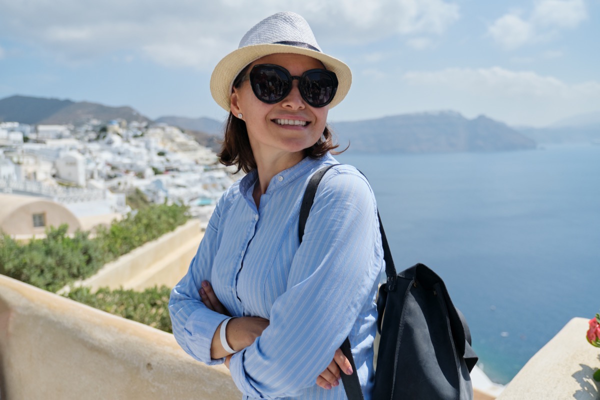 Smiling,Woman,Tourist,Traveling,On,Luxury,Cruise,In,Mediterranean,,Greece,