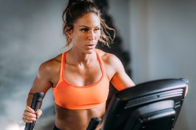 Woman Exercising on Elliptical Cross Trainer