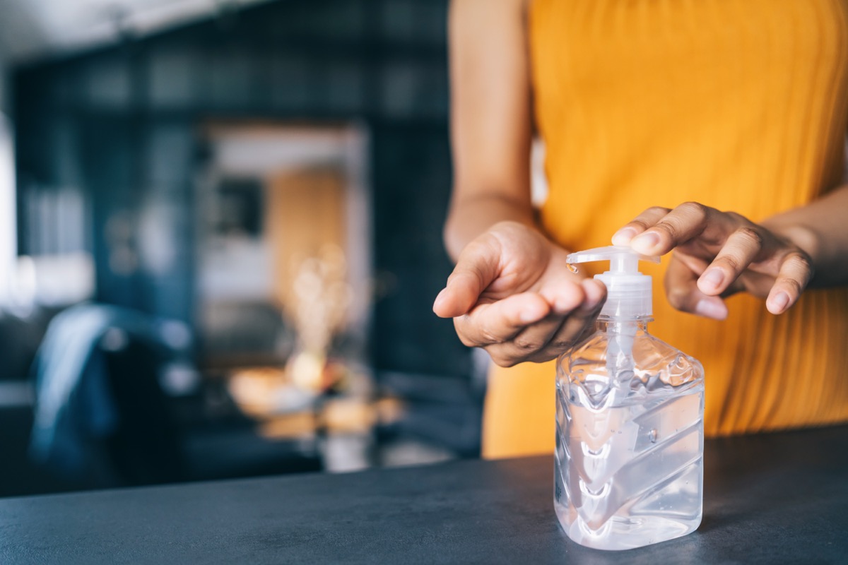 Woman applying hand sanitizer.