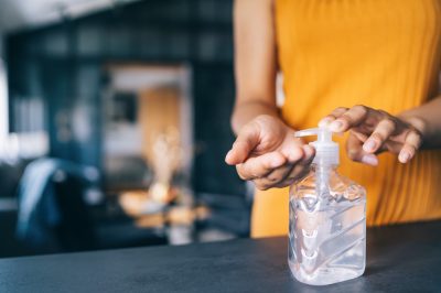 Woman applying hand sanitizer.