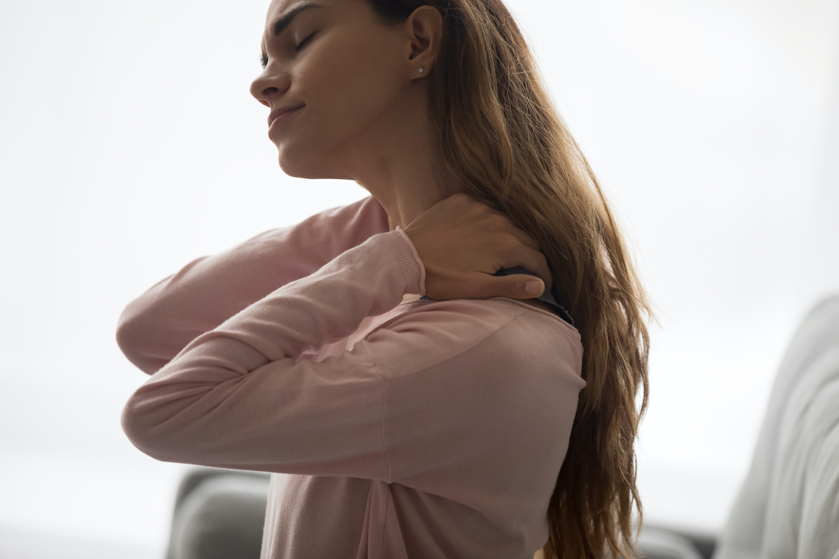 Exhausted,Young,Lady,Sitting,On,Couch,,Massaging,Neck,,Suffering,From