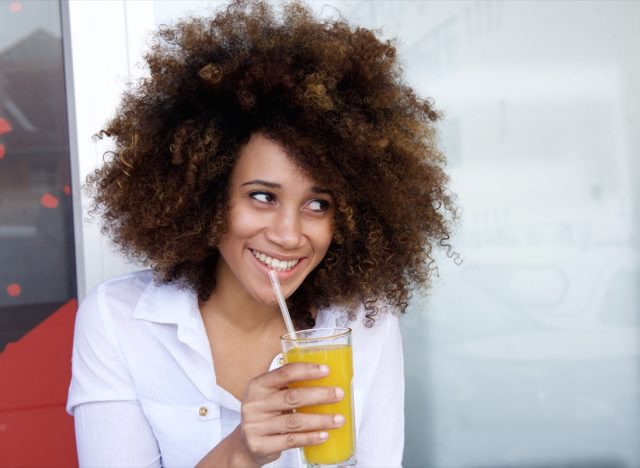 young woman drinking juice